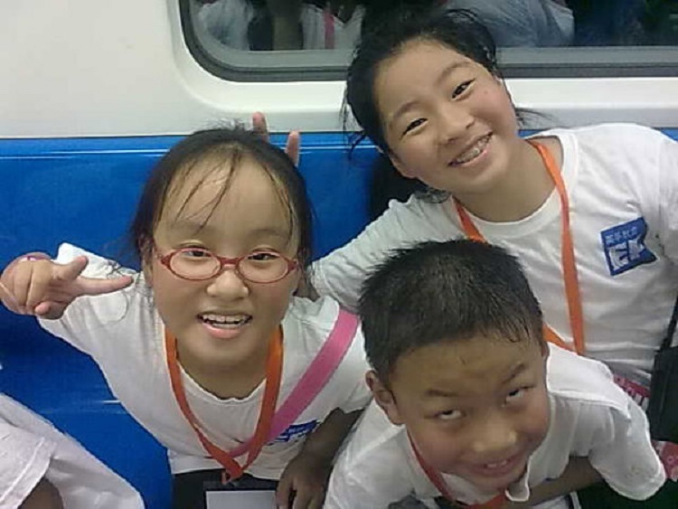 Three young students in China learning English.