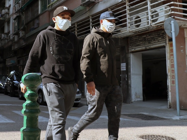 Two Chinese men wearing face masks due to coronavirus